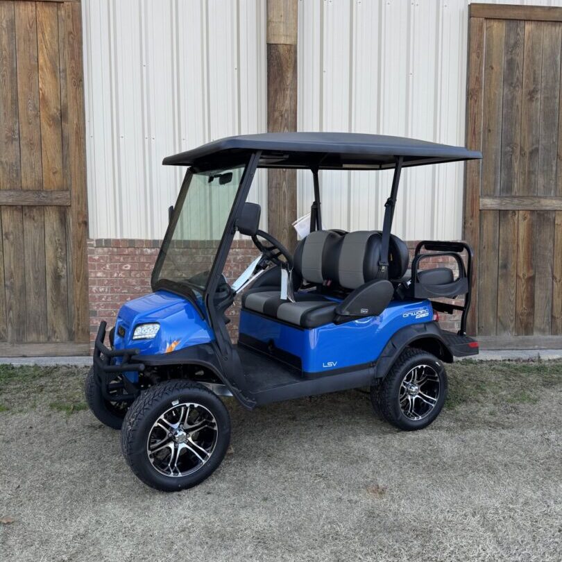 Blue golf cart with black roof and lifted wheels parked outdoors.